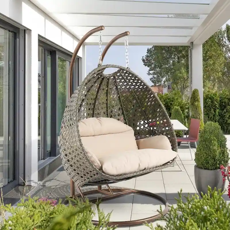 4d1bcdaf26f5988bd30021f437c064bdb3fe29ac613e66308149e8894a81667e LeisureMod 2 Person Hanging Egg Chair with Stand - Outdoor/Indoor Rattan Wicker Patio Swing Hammock Lounger with Cushions(Beige)